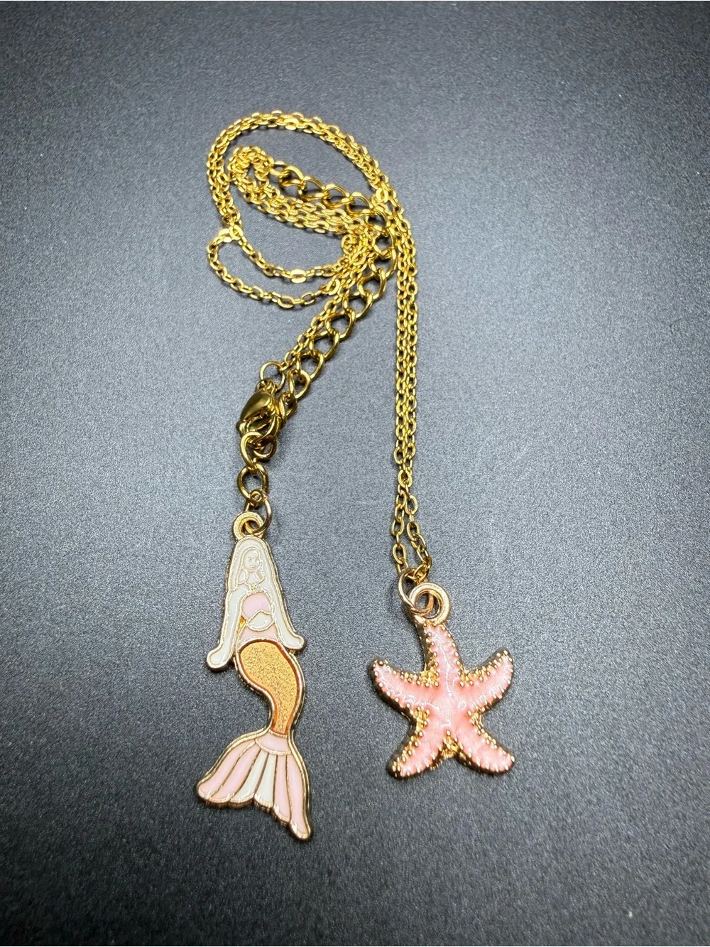Gold tone Starfish Pendant Necklace with Pink Enamel mermaid in the back.